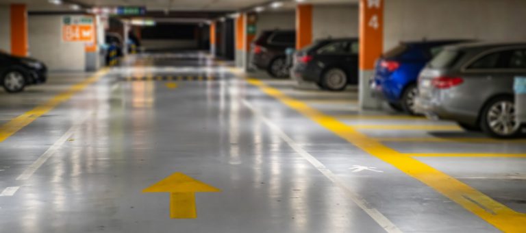 Yellow,Markings,With,Blurred,Modern,Cars,Parked,Inside,Closed,Underground