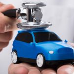 Close-up,Of,A,Doctor's,Hand,Examining,Blue,Car