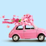 Pink,Toy,Car,With,Bouquet,Of,Flowers,On,A,Roof