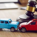Little,Crashed,Autos,On,Table,In,Courtroom.,Gavel,And,Two