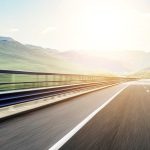 White,Car,Rushing,Along,A,High-speed,Highway.,Toned,Photo.