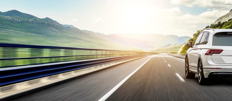 White,Car,Rushing,Along,A,High-speed,Highway.,Toned,Photo.