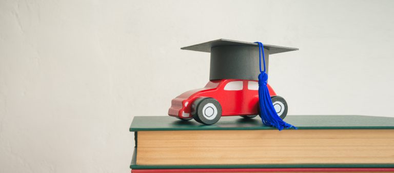 Graduation,Cap,On,Wooden,Car,Over,The,Pile,Of,Books
