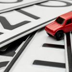 Close-up,Of,Car,License,Plates,With,A,Toy,Car,,The