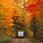 Epic,Camper,Van,Drives,On,Dirt,Road,In,Colorful,Autumn